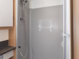 The shower might have a rather low entry height for taller people, but it does have two drainage holes, an LED and a rail for drying clothes
