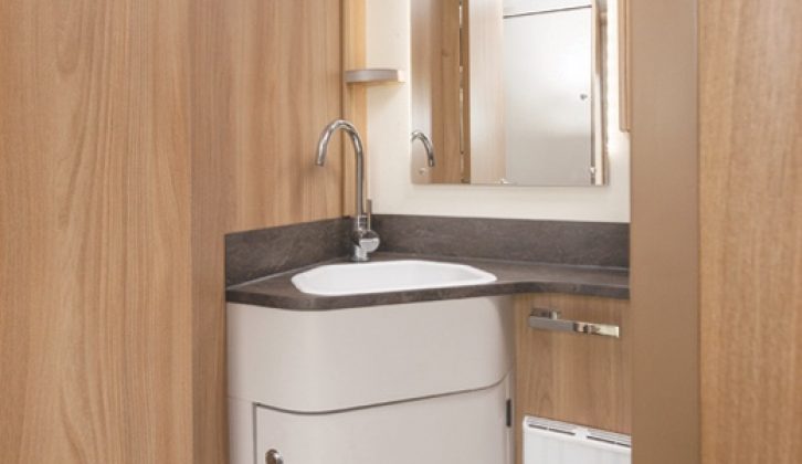 The washroom has the more conventional-style basin, rather than the salad-bowl, and plenty of storage in shelving and cupboards