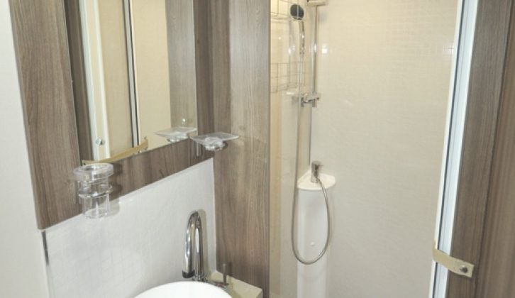 Washroom includes countertop handbasin and a very generous shower cubicle