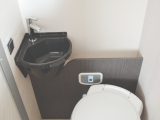 The toilet and accompanying basin have their own cubicle
