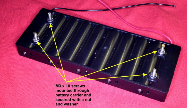 6. The four battery carrier mounting screws in position