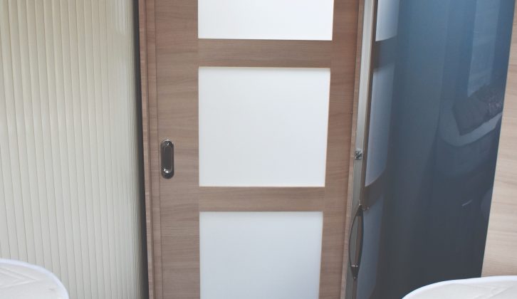 A panelled door partitions off the rear bedroom for privacy