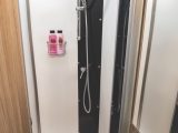 Lined shower cubicle is a good size and includes riser bar and storage rack