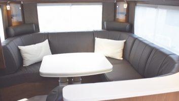 Sumptuous C-shaped lounge at rear, here with optional leather upholstery,; another extra allows the front of the settee to convert into two additional travel seats