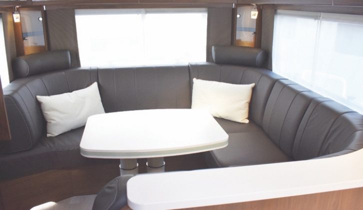 Sumptuous C-shaped lounge at rear, here with optional leather upholstery,; another extra allows the front of the settee to convert into two additional travel seats