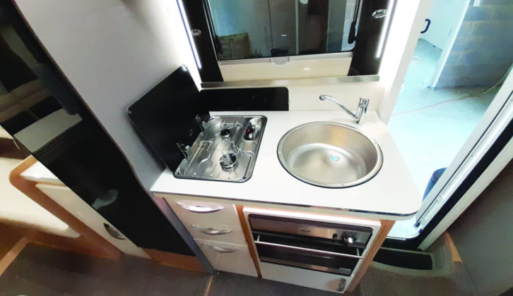 In the kitchen, the two-burner gas hob is positioned side-on