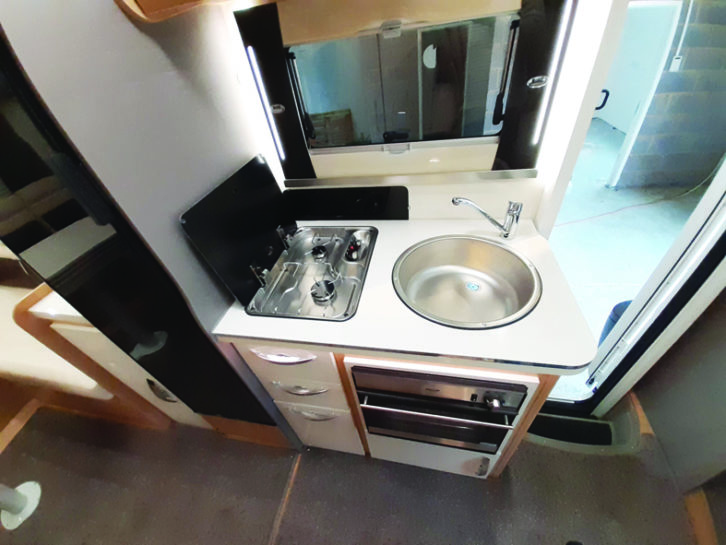 In the kitchen, the two-burner gas hob is positioned side-on