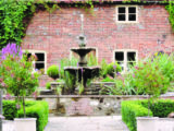Picturesque fountain in the farmhouse gardens at Common Leys Farm