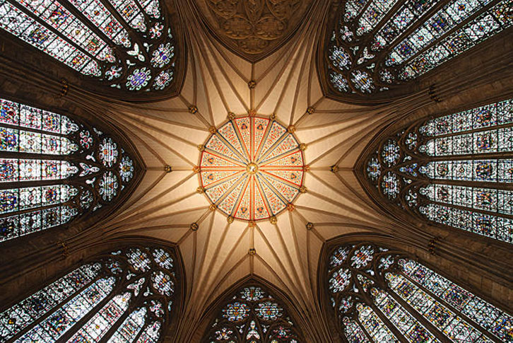 Looking up at York Minster's ceiling and stain glass windows