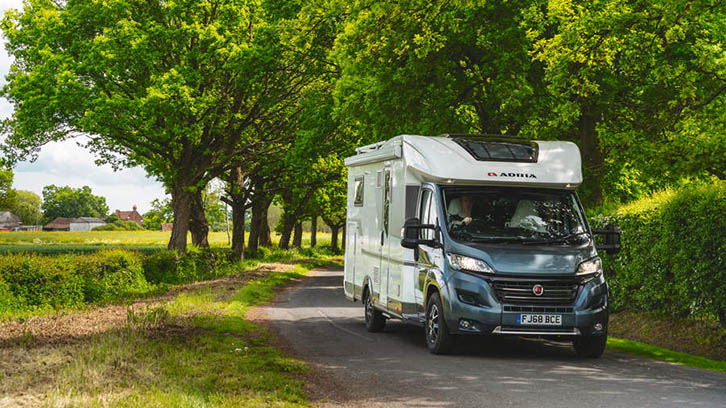 Motorhome driving down a leafy lane