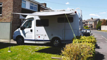 Motorhome parked on driveway with an awning