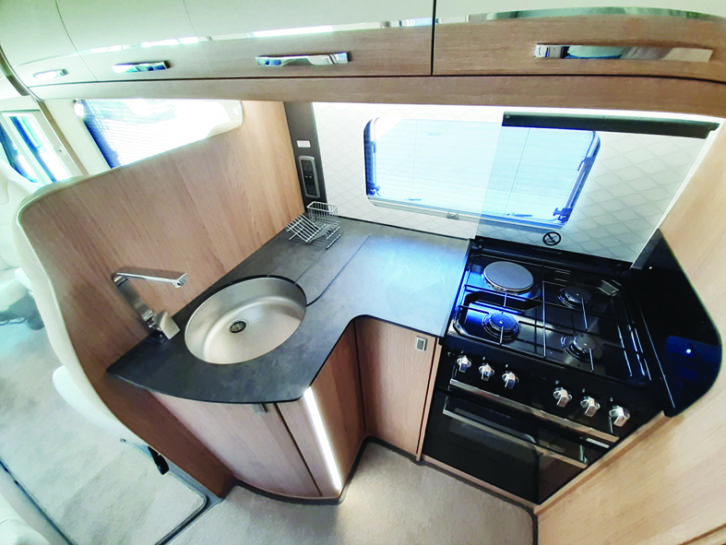 Generous worktop in the kitchen looks like real slate, but is actually much lighter compact laminate