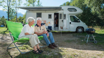 A couple sat in front of their motorhome