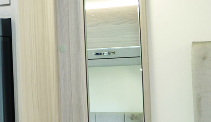Mirrored locker cupboard is located at the foot of the bed