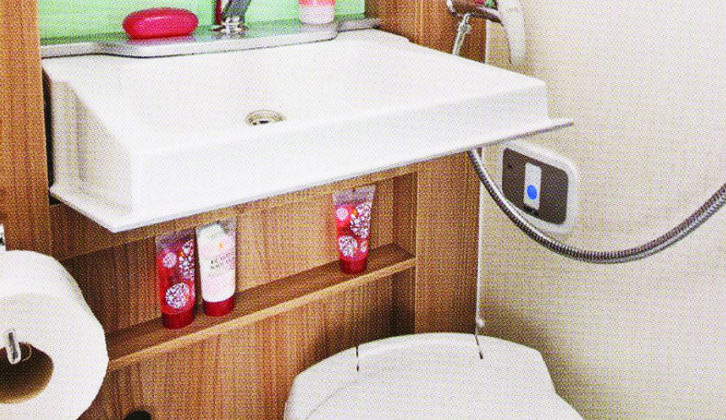 Well-appointed comfort station consists of toilet, foldaway basin, shower and storage