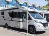 An Adria motorhome parked on a dealer forecourt