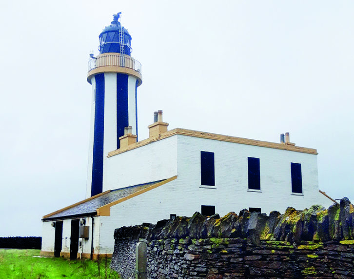 Uniquely striped lighthouse at Start Point dominates the coastal skyline