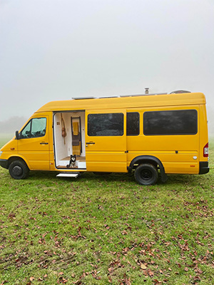 The bright yellow exterior of the campervan