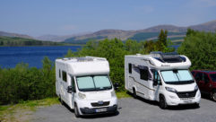 Motorhomes parked with the coast in the background