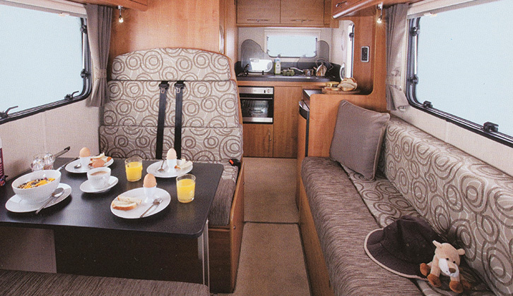 The lounge of the 'van with breakfast on the table