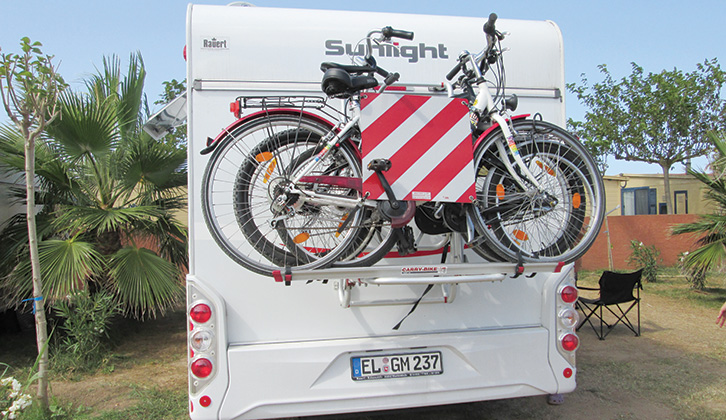 Bikes attached to a rack on the rear of a motorhome