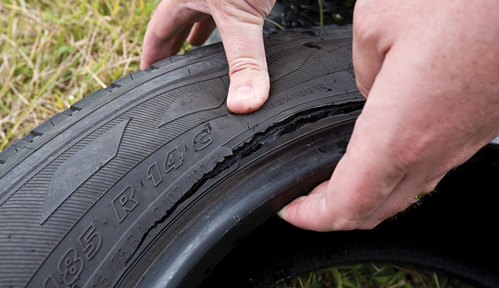 The tyre sidewall being checked for cuts