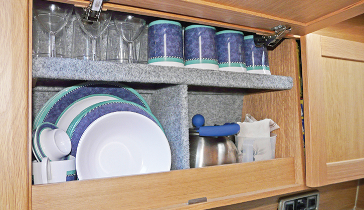 Crockery stored in a motorhome cupboard