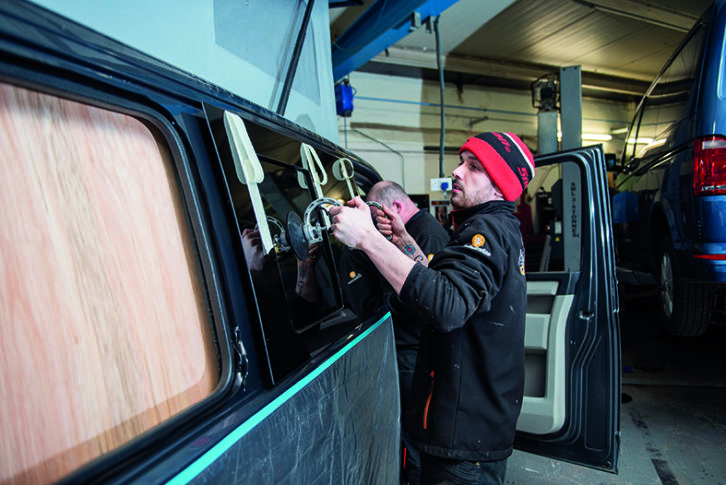 New window being fitted to the freshly cut bodywork