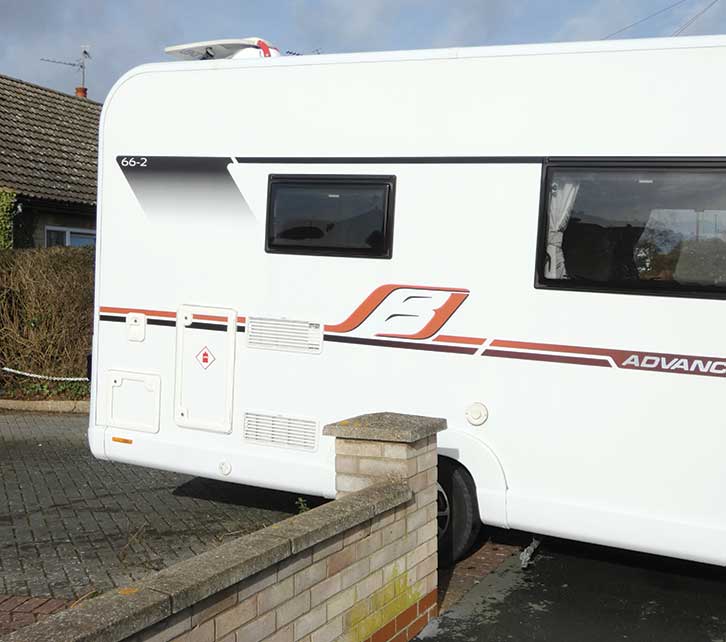 Motorhome emerging from narrow opening