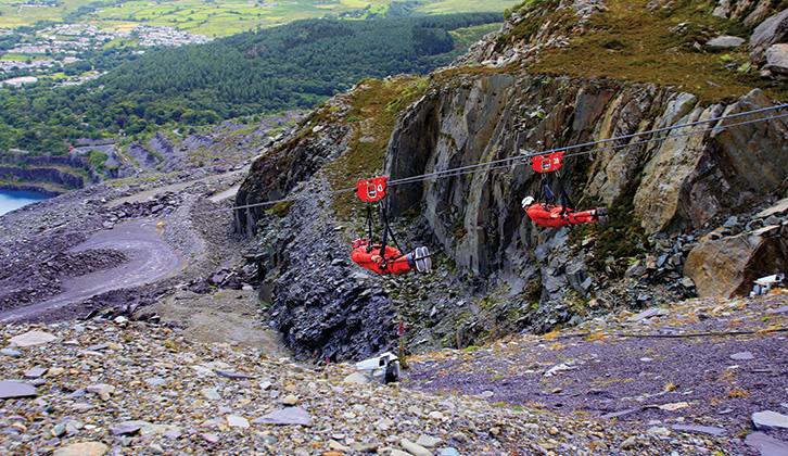 Two people on a zipwire at Zipworld