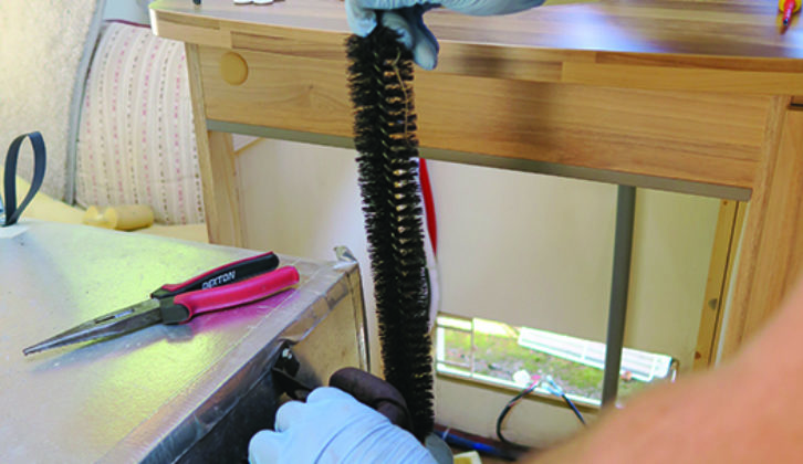 Purpose-made wire brush helps rid flue of sooty deposits