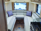 Comfortable lounge gains plenty of natural light from large windows at the rear and sides