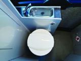 'Washroom' zone provides a Dometic electric-flush toilet, deep stainless-steel handbasin and a hot water supply
