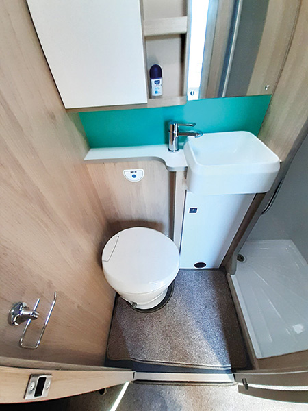 The washroom doesn't have a window but the minty green splashback helps to freshen up the area