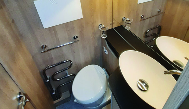 Side washroom has a salad-bowl-style basin, large mirror and plenty of cupboard space