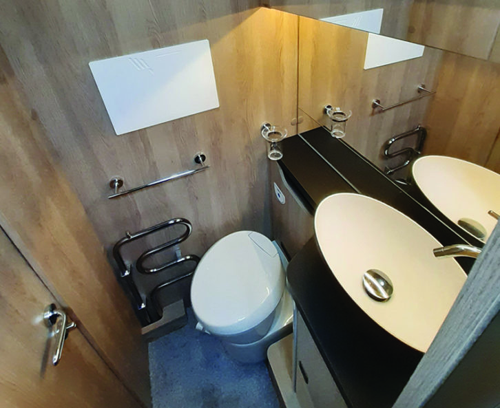 Side washroom has a salad-bowl-style basin, large mirror and plenty of cupboard space