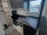 Plenty of worksurface in well-lit kitchen, above 135-litre fridge and at lower level by sink and hob