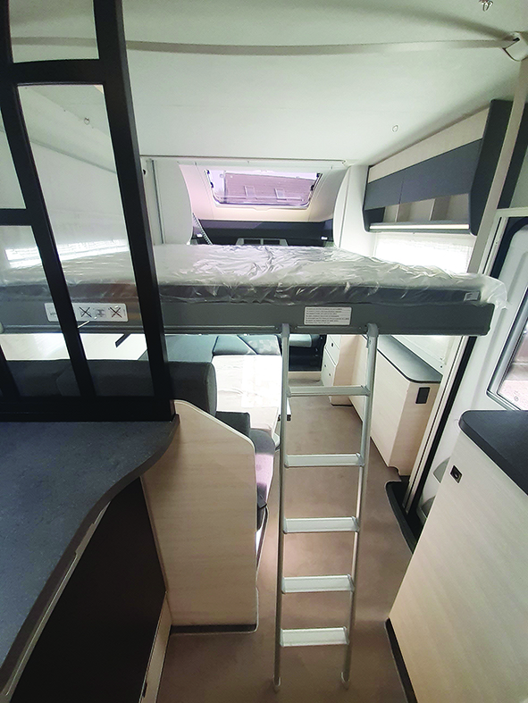 Comfortable ceiling bed is accessed by ladder