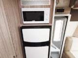 145-litre AES fridge has a separate freezer, and microwave is just above