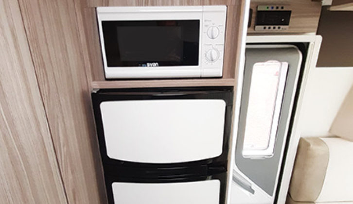 145-litre AES fridge has a separate freezer, and microwave is just above