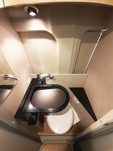 A large, sleek handbasin can be folded neatly away