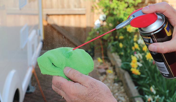 Silicon lubricant being sprayed onto a cloth