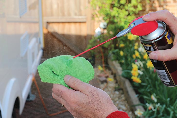 Silicon lubricant being sprayed onto a cloth