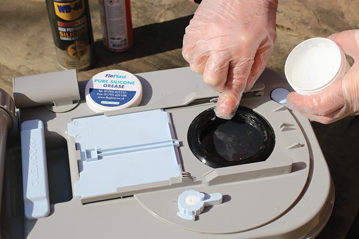 Smearing silicone grease around the rubber seal