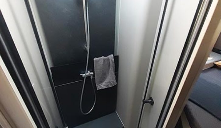 The shower, with a black side wall and tray