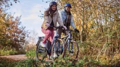 Two people cycling through the countryside