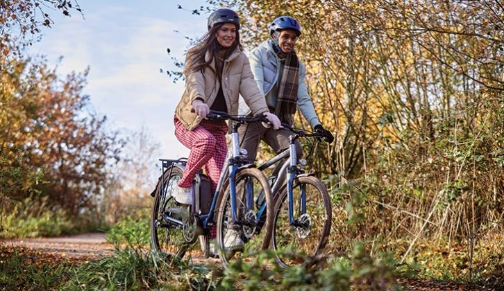Two people cycling through the countryside