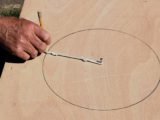 Two circles being drawn on the plywood
