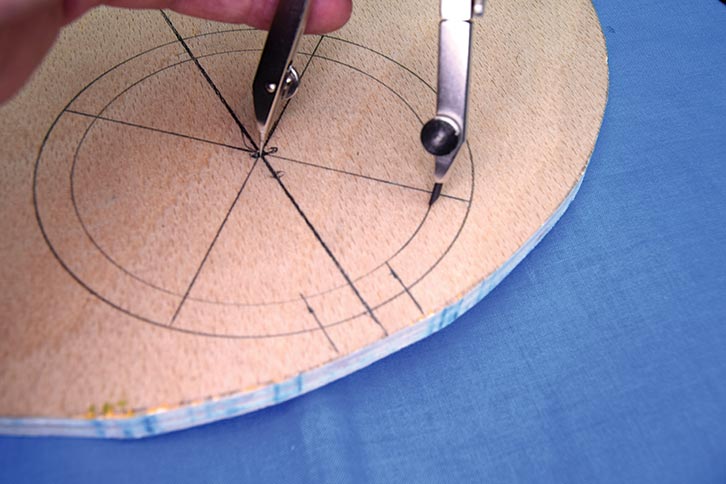 A pair of compasses being used to mark up the cutting areas