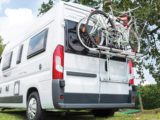 A bike rack attached to the rear of a motorhome